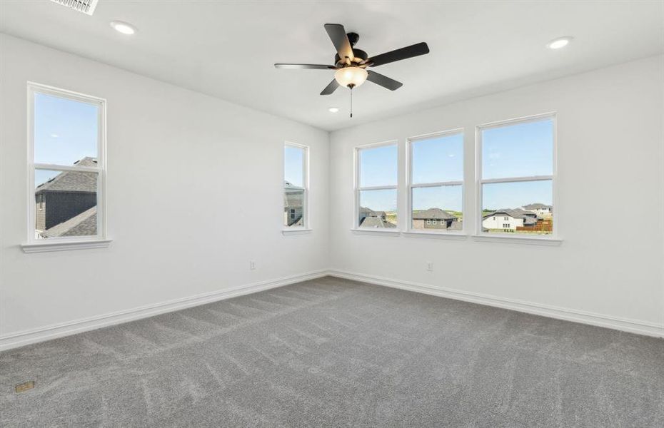 Spacious secondary bedroom features ample closet space *Real home pictured