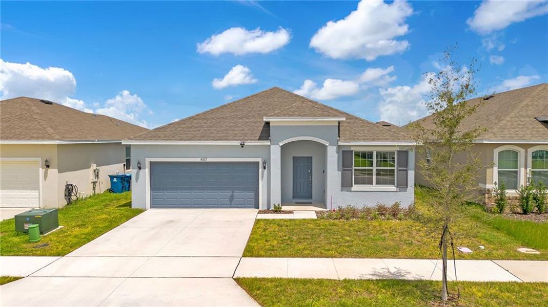 Front exterior of a new home in Cypress Park Estates, Haines City, FL, highlighting curb appeal (Image 24).