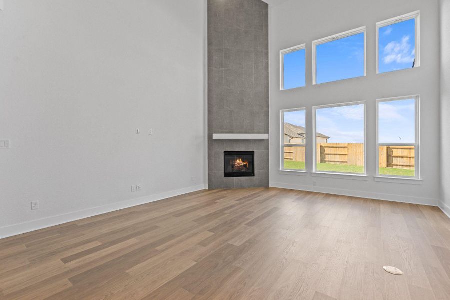 Family Room with soaring ceiling & fireplace