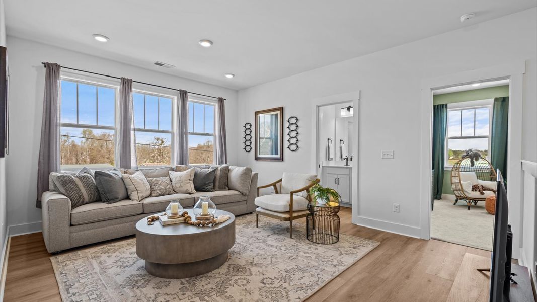 Functional loft with tasteful hardwood floors and exceptional natural light in a modern home