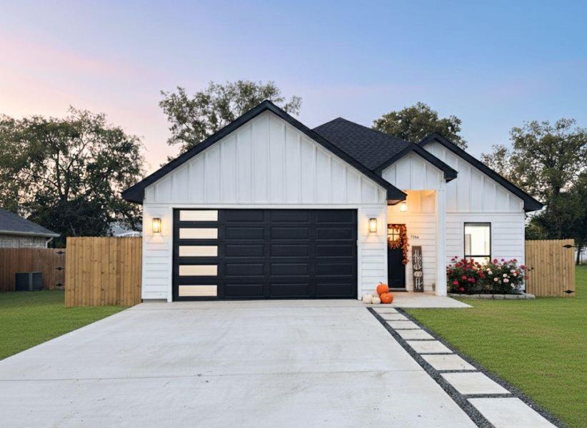 View of front facade with board and batten siding, driveway, and an attached garage View of front facade with board and batten siding, driveway, and an attached garage