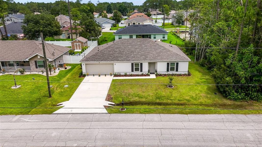 Front exterior of a new home in Palm Coast, Palm Coast, FL, highlighting curb appeal (Image 22). Front exterior of a new home in Palm Coast, Palm Coast, FL, highlighting curb appeal (Image 22).