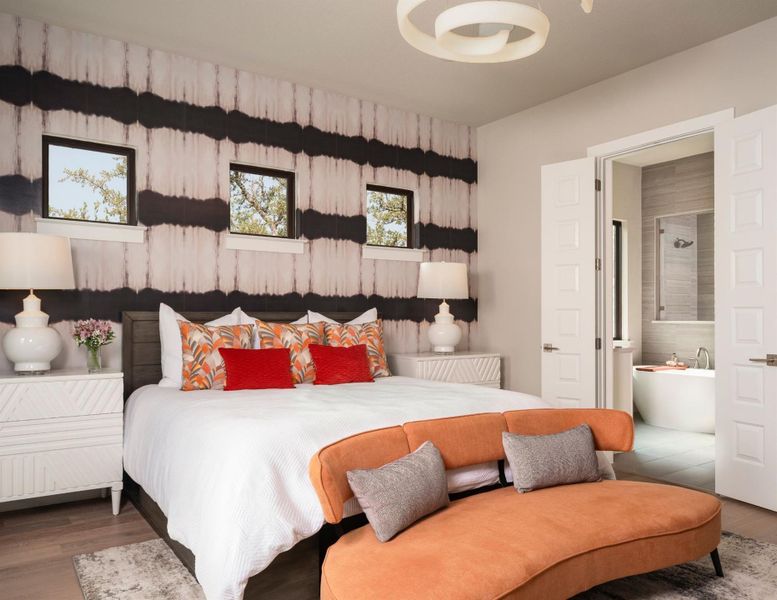 Bedroom with wood finished floors and connected bathroom