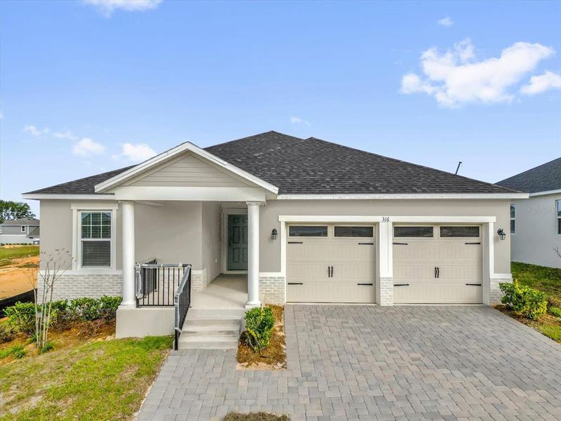 Front exterior of a new home in Cypress Bluff II, Groveland, FL, highlighting curb appeal (Image 1). Front exterior of a new home in Cypress Bluff II, Groveland, FL, highlighting curb appeal (Image 1).
