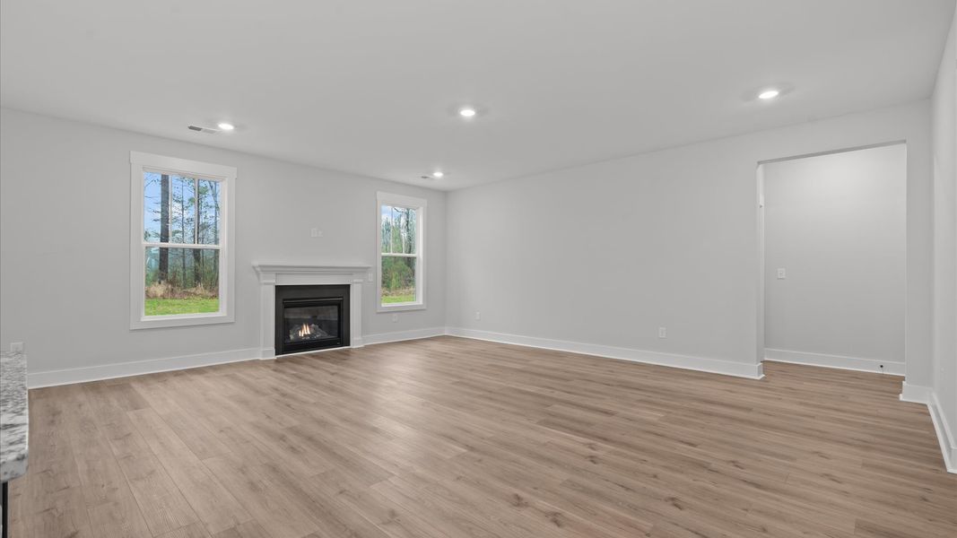 Elegant family room with hardwood flooring and open-concept flow in this first-class DRB Homes design