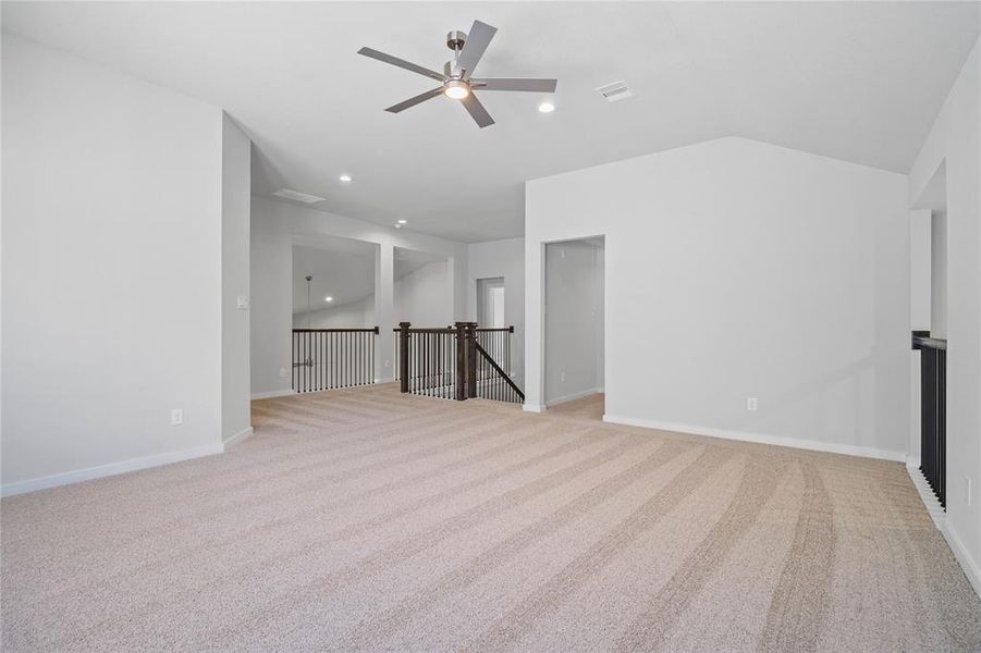 Another view of the game room looking out towards the staircase and entrances to the secondary bedrooms.