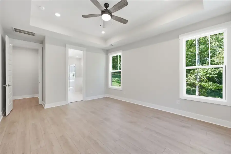 Clean lines and a tray ceiling define this light-f