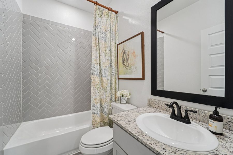 Bluestem Model Home - Matagorda - Secondary Bathroom Down Bluestem Model Home - Matagorda - Secondary Bathroom Down