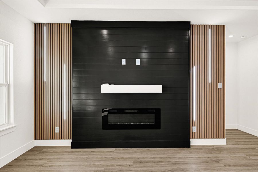 Electric fireplace with decorative wall panels and modern lights