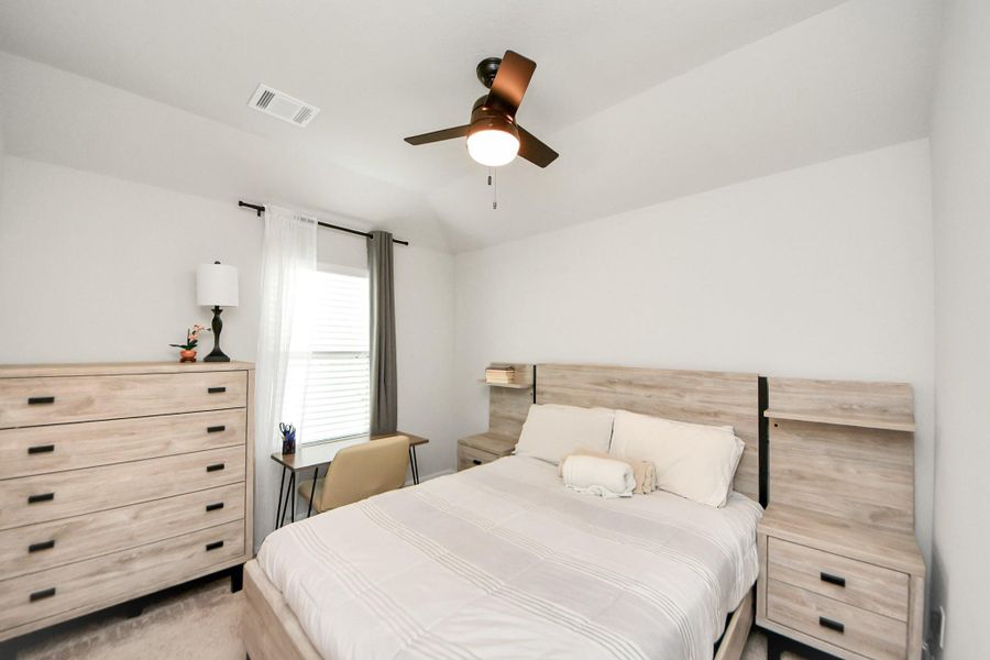 Spacious 3rd bedroom with ceiling fan and a large window that allows tons of natural lighting.