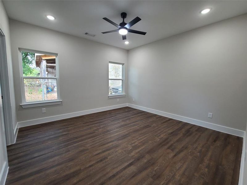 Spare room featuring dark hardwood / wood-style flooring and ceiling fan