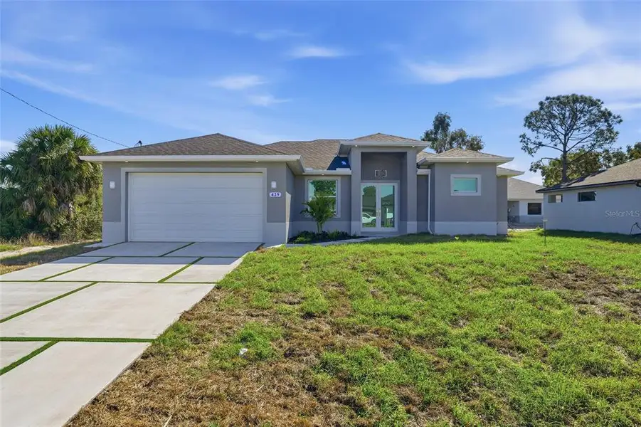 Front exterior of a new home in , Lehigh Acres, FL, highlighting curb appeal (Image 21).