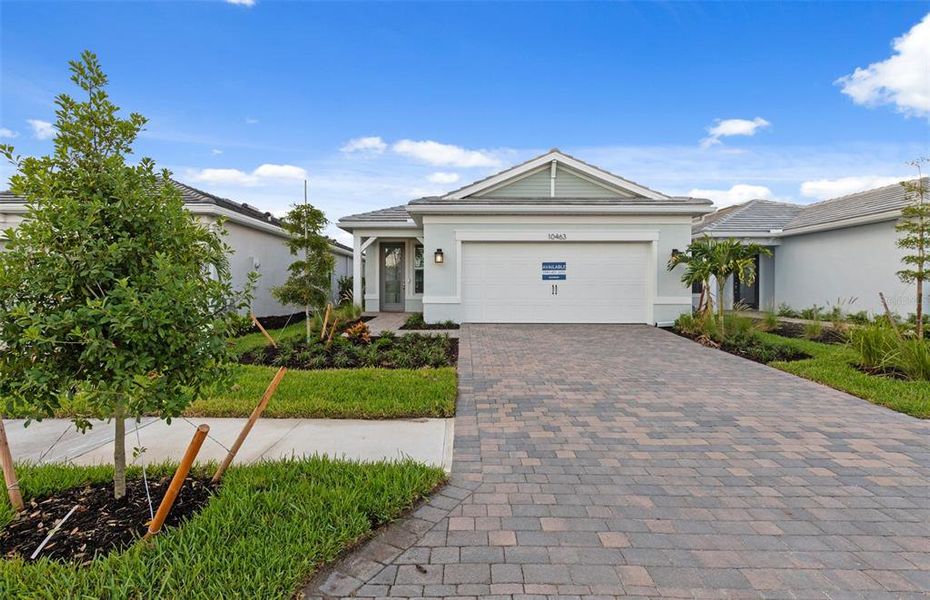 Front exterior of a new home in BeachWalk by Manasota Key, Englewood, FL, highlighting curb appeal (Image 1). Front exterior of a new home in BeachWalk by Manasota Key, Englewood, FL, highlighting curb appeal (Image 1).