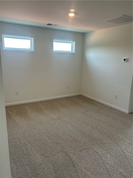 Plush carpeting and well-placed windows create a p