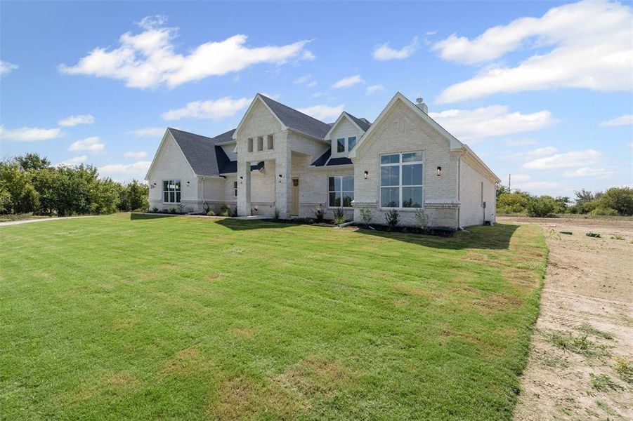 View of front of property with brick siding and a front yard View of front of property with brick siding and a front yard