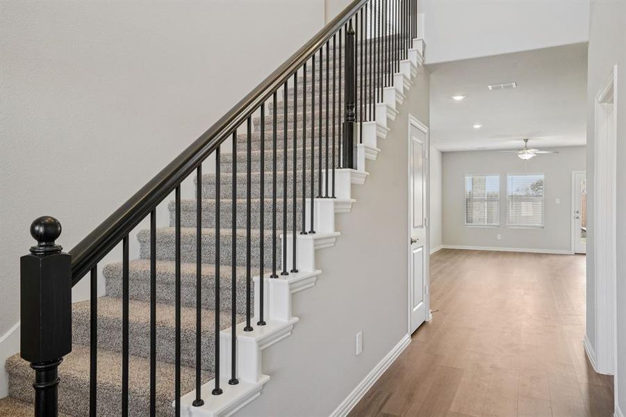 Stairs featuring ceiling fan, wood finished floors, and recessed lighting