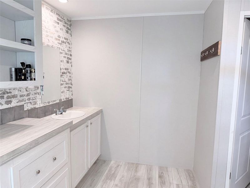 Well-lit vanity area with a crisp, clean aesthetic.