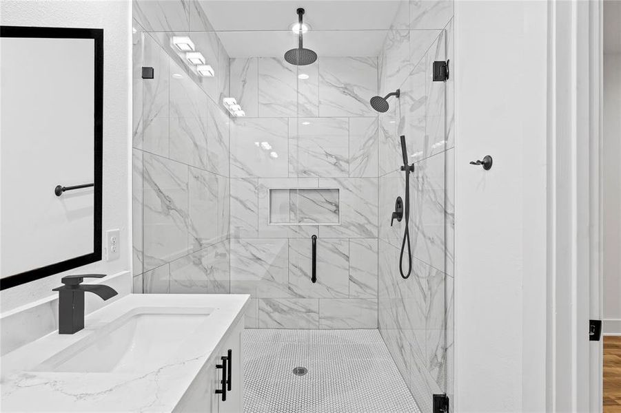 Bathroom with vanity, wood-type flooring, and an enclosed shower