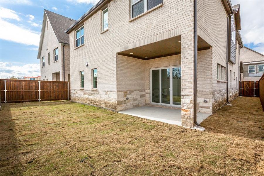 Rear view of property featuring a patio area and a yard