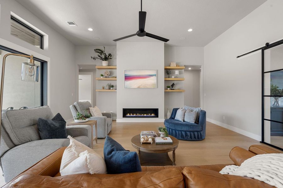 Gleaming hardwood floors and a modern linear fireplace anchor this inviting living space.