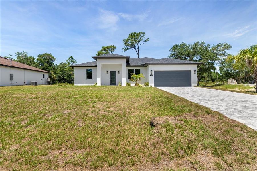 Front exterior of a new home in , North Port, FL, highlighting curb appeal (Image 22). Front exterior of a new home in , North Port, FL, highlighting curb appeal (Image 22).