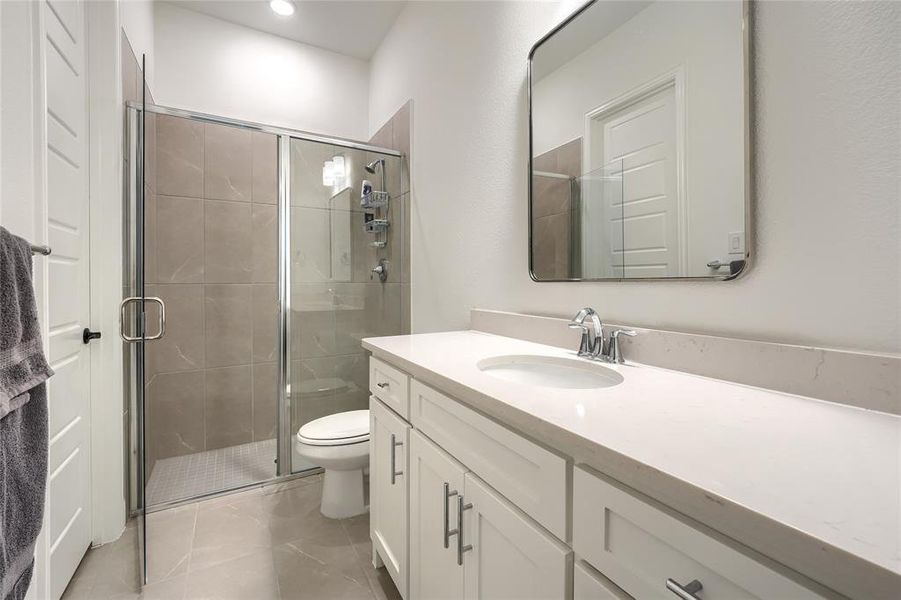 Full bathroom with vanity and a stall shower