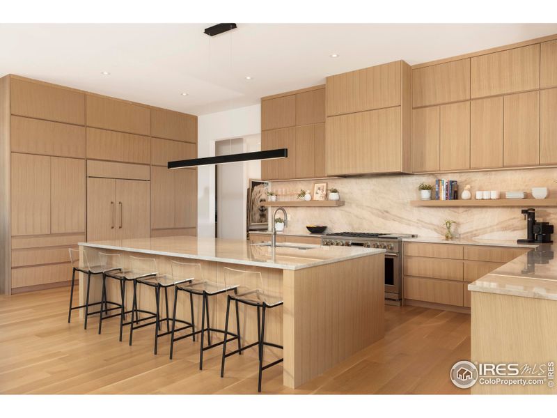 The chef's kitchen features a marble backsplash, floating shelves, and a large island with an undermount sink, complemented by paneled GE Monogram and Bosch appliances, including a 6-burner range. The chef's kitchen features a marble backsplash, floating shelves, and a large island with an undermount sink, complemented by paneled GE Monogram and Bosch appliances, including a 6-burner range.