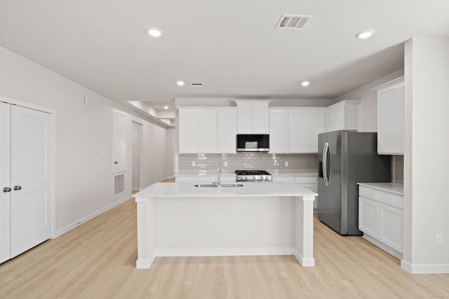 A kitchen with white cabinets. A kitchen with white cabinets.