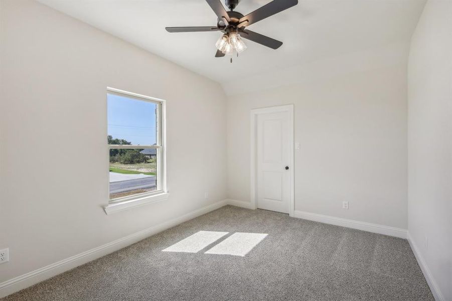 Empty room featuring carpet and ceiling fan