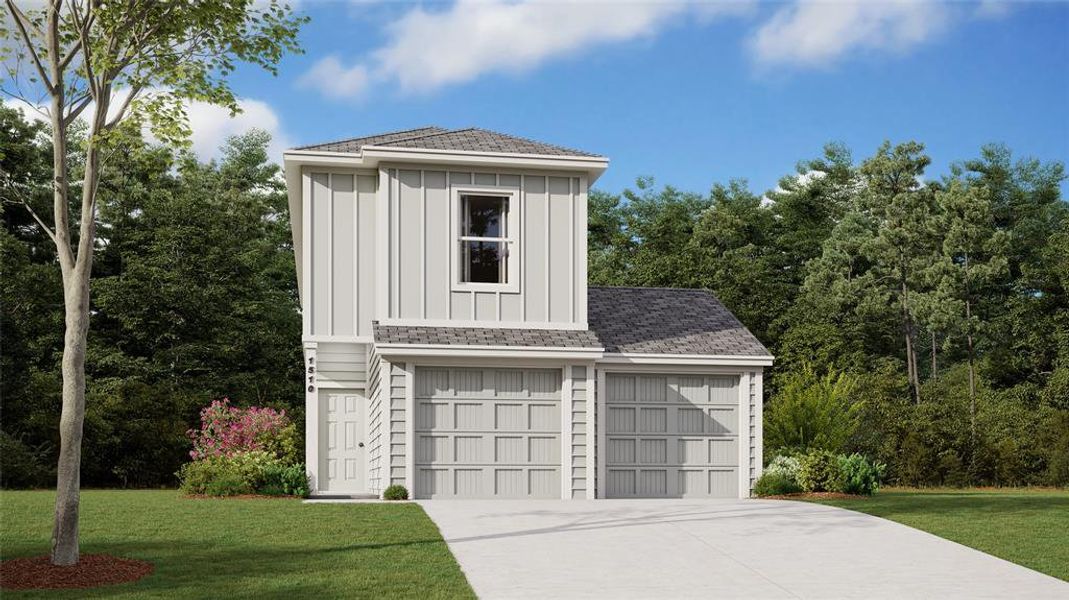 View of front of property with a garage and a front yard