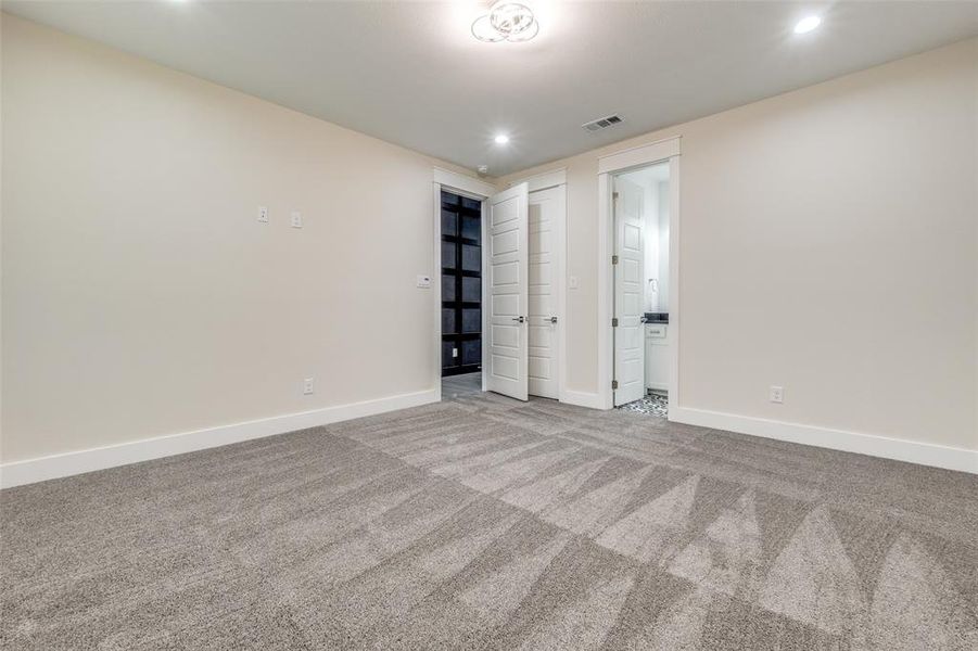 Unfurnished bedroom with carpet and ensuite bath