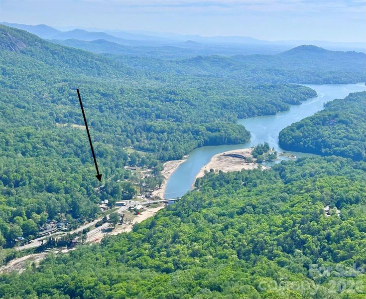 Located where the Rocky Broad River flows into Lake Lure. This view of the home is from Chimney Rock!