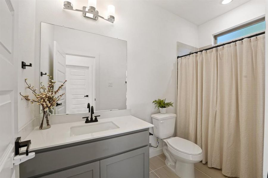 Full bathroom with a shower with curtain and vanity