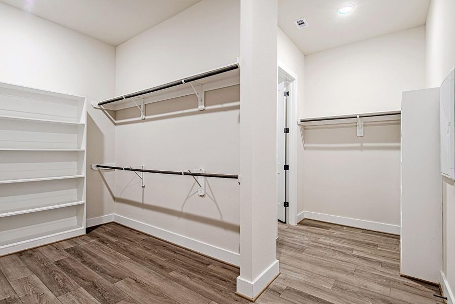 Expansive primary closet offering exceptional organization space Expansive primary closet offering exceptional organization space