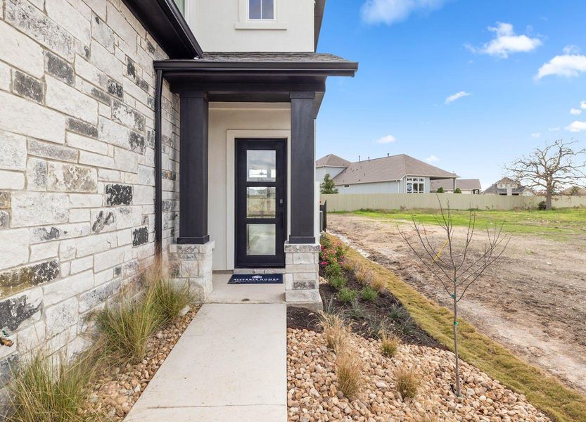 Entrance to property featuring stucco siding and stone siding Entrance to property featuring stucco siding and stone siding