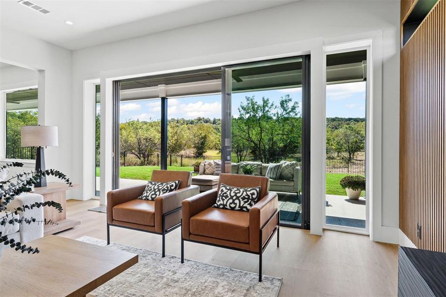 Entryway featuring wood finished floors, view of scattered trees, and recessed lighting