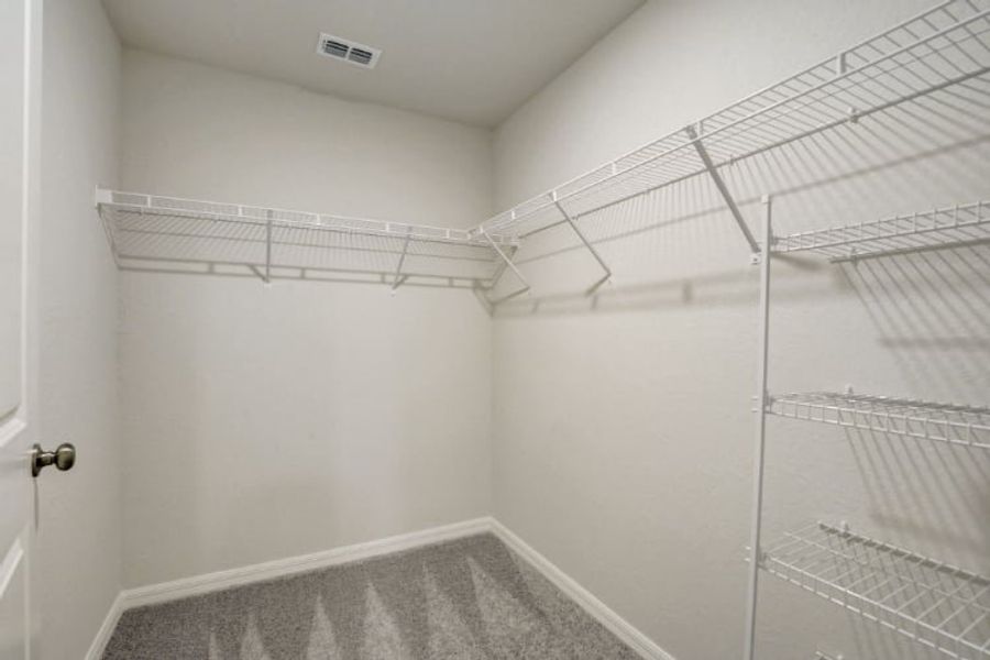 A white room with a metal rack.