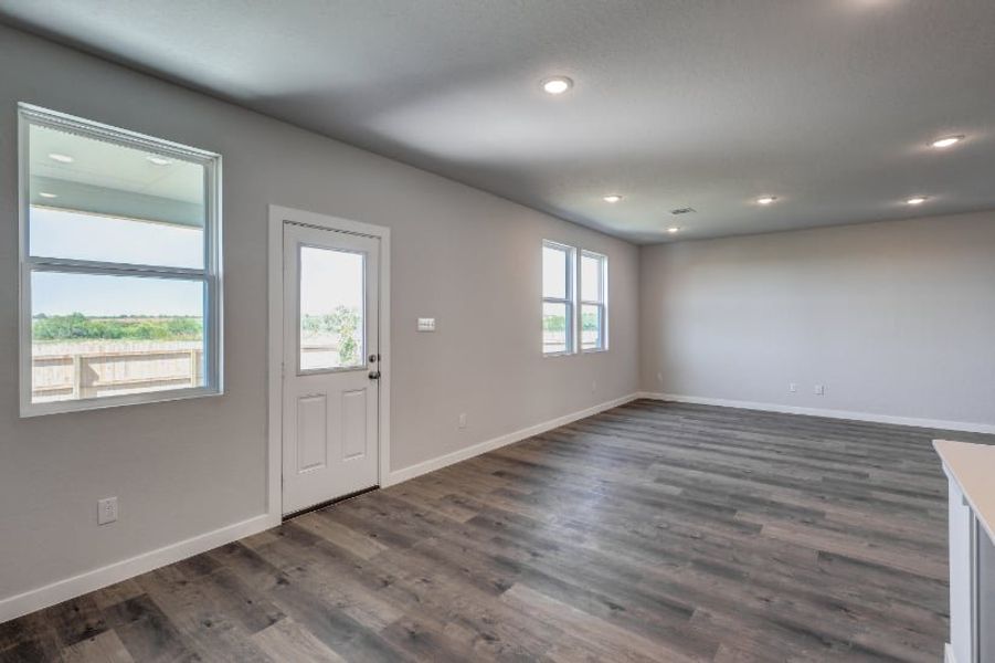 A room with windows and a wood floor. A room with windows and a wood floor.