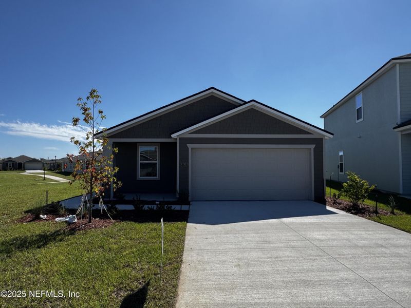 Front exterior of a new home in The Arbors, Jacksonville, FL, highlighting curb appeal (Image 2).