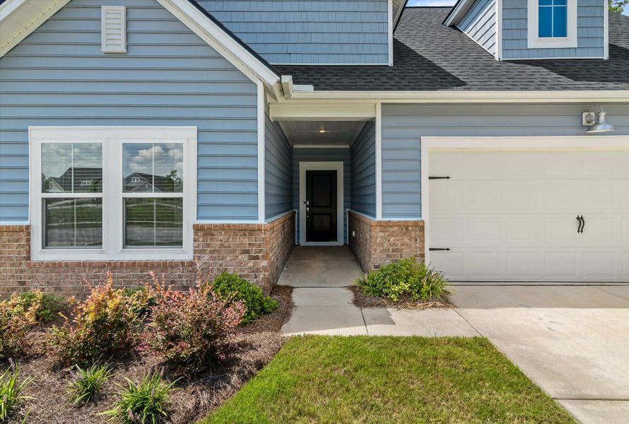 Front exterior of a new home in Horizons at Summers Corner | 55+: The Legends, Summerville, SC, highlighting curb appeal (Image 19). Front exterior of a new home in Horizons at Summers Corner | 55+: The Legends, Summerville, SC, highlighting curb appeal (Image 19).