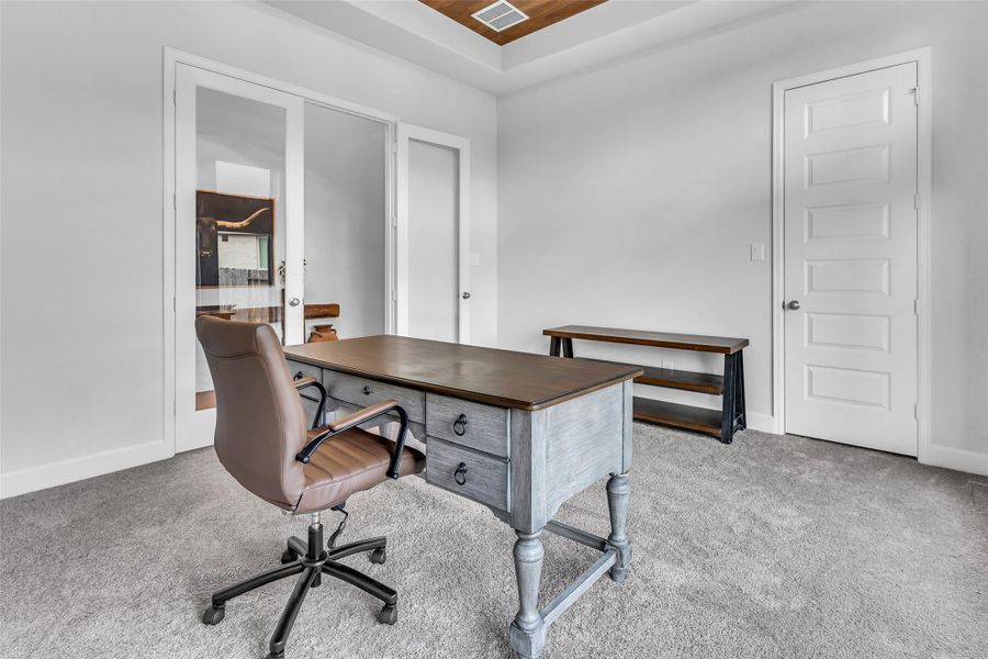 Private office with French doors. Can also be used as a game room.