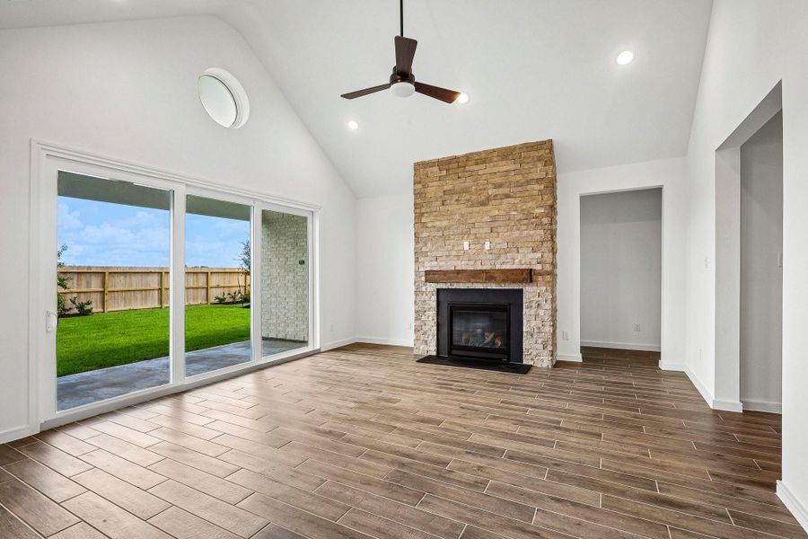 Bright and airy great room with sliding glass doors to the patio and a fireplace Bright and airy great room with sliding glass doors to the patio and a fireplace