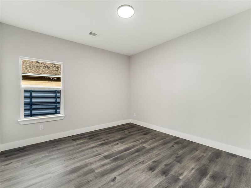 Unfurnished room featuring dark hardwood / wood-style floors