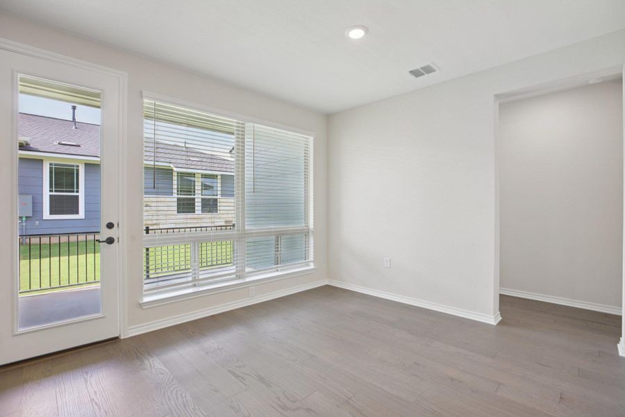 Empty room featuring light wood-style flooring and recessed lighting