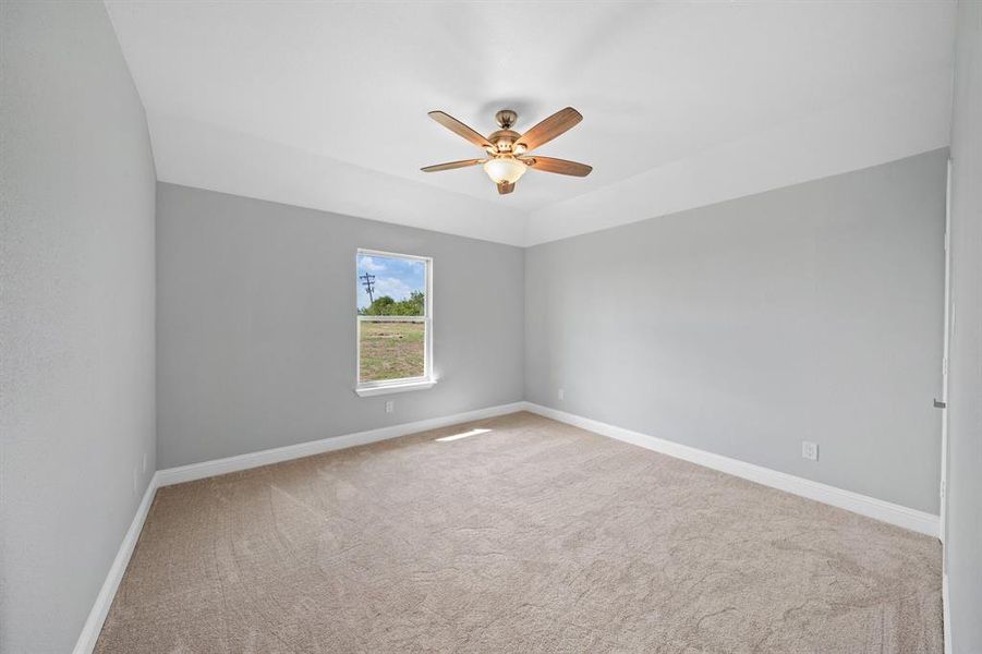 Empty room with light carpet and ceiling fan