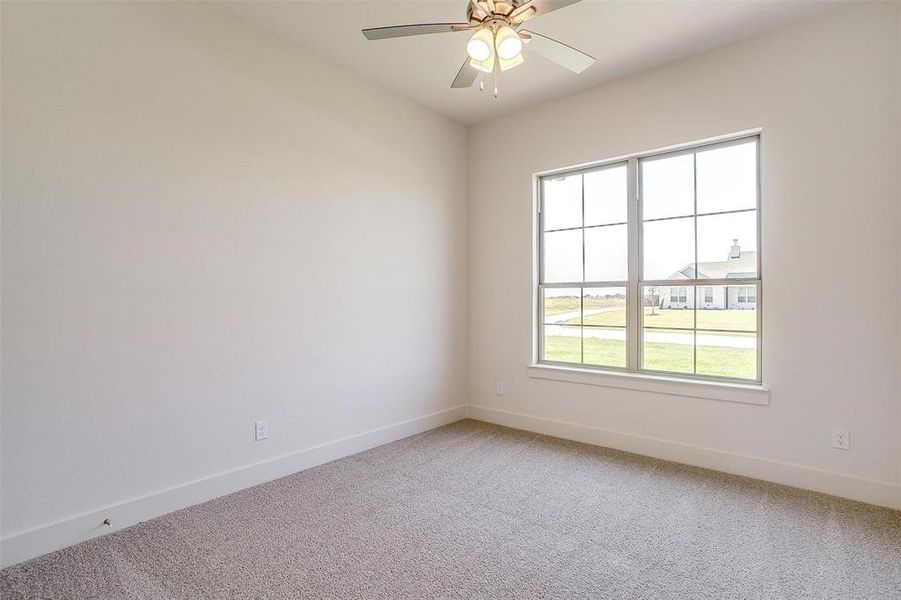 Empty room with carpet flooring and ceiling fan