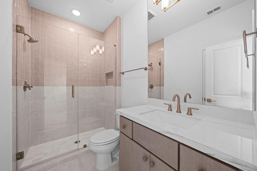 Elegant bathroom featuring glass enclosed shower, refined finishes, and a spacious layout.