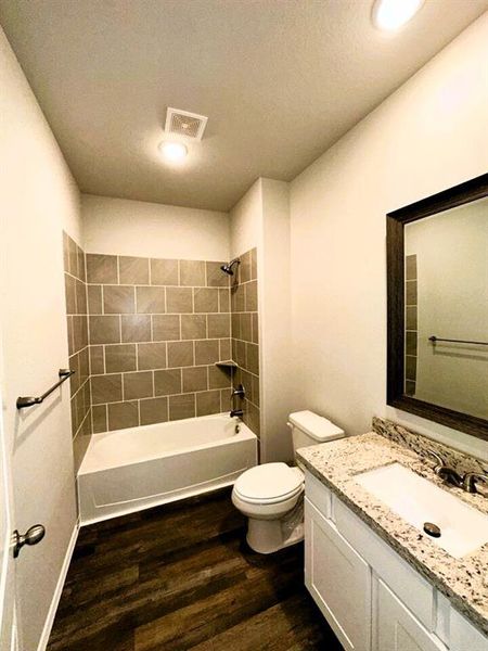 Bath 2 includes granite counters, framed mirror, ceramic tile tub/shower walls & shelving for your linens.