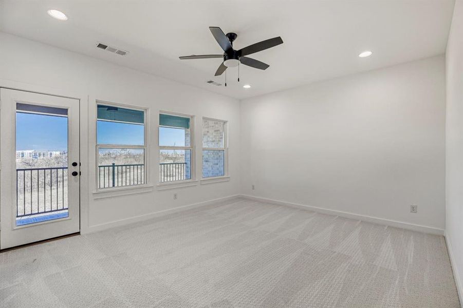 Empty room with ceiling fan, light carpet, and recessed lighting