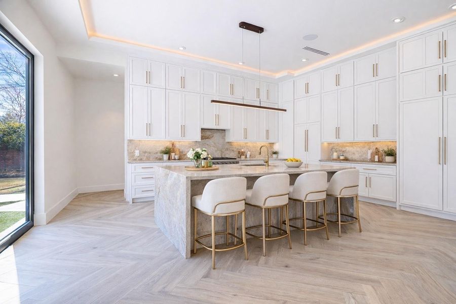 Chef’s kitchen with oversized island, custom cabinetry, and premium appliance package. Chef’s kitchen with oversized island, custom cabinetry, and premium appliance package.